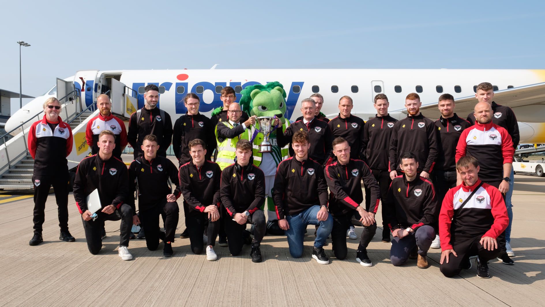 FC Isle of Man players pose for a photo upon arrival at Guernsey Airport.