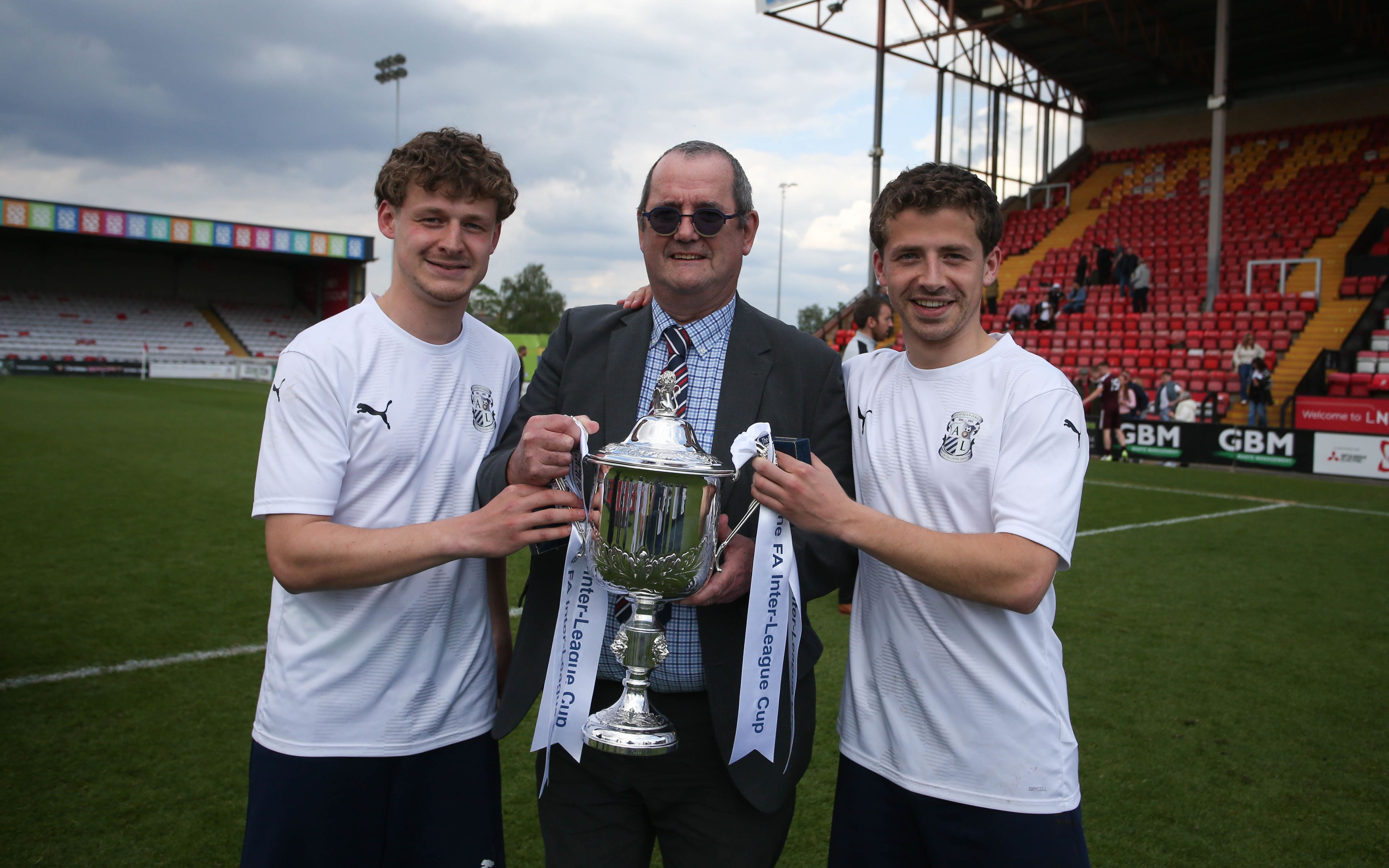 Nick Robinson presents a trophy at Lincoln City's Sincil Bank.