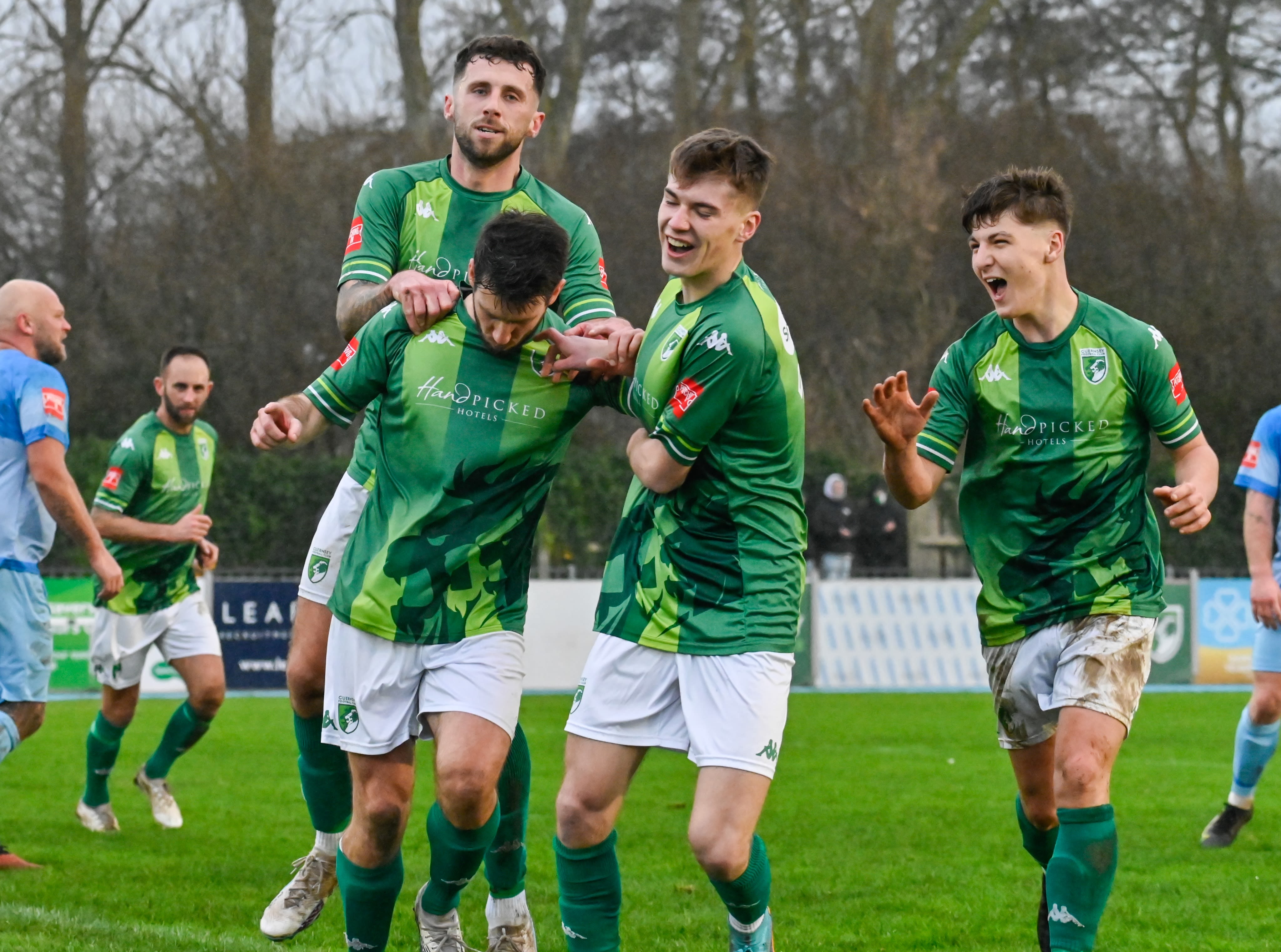 Guernsey players celebrate scoring a goal.